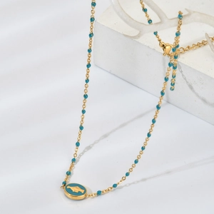 Collier fin en acier inoxydable doré avec perles bleues et pendentif dauphin ovale