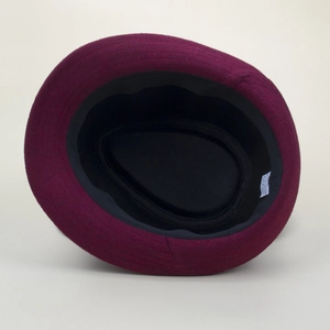 Detail view of the deep purple felt hat interior featuring a black sweatband and care label