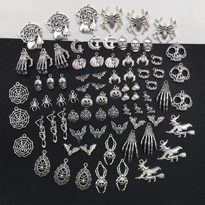 Mix of Halloween charms including spider webs, skeletons, bats, and pumpkins for DIY crafts