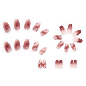 Pink and purple gradient press-on nails with cherry blossom patterns and gold glitter accents