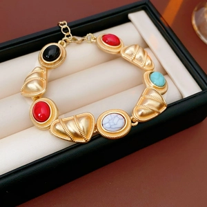 Detail of vintage gold bracelet with colorful beads in a black jewelry box