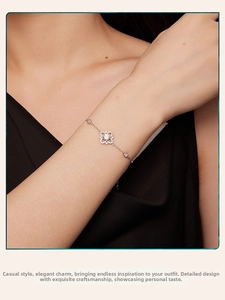 Close-up of S925 sterling silver moissanite bracelet on wrist with floral charm
