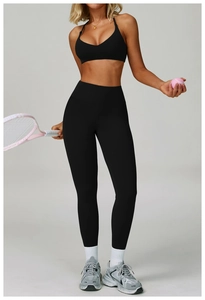 Detail of high-waist black yoga leggings featuring tummy control and moisture-wicking fabric