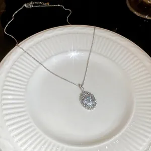 Elegant oval zircon pendant necklace with light blue gemstone and radiant diamond halo detail