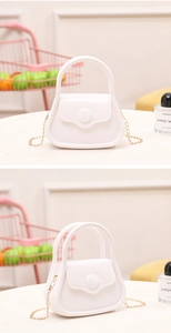 Detailed view of mini white PVC jelly bag with golden chain strap and round buckle