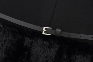 Close-up of black faux fur dress with matching leather belt and silver buckle detail