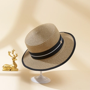 Classic flat top straw boater hat with black ribbon and gold bee accent for beach travel