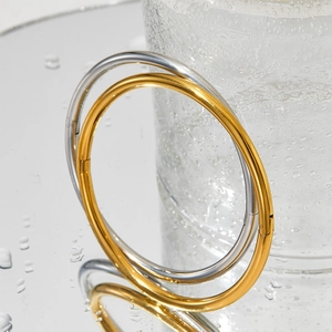 Pair of gold and silver minimalist titanium steel bangles with secure hinge clasp