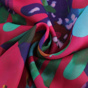 Macro view of colorful floral print fabric showing the smooth texture and soft drape