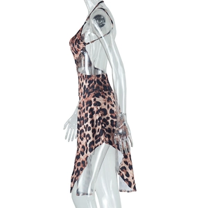 Detail of leopard print halter dress featuring backless design and asymmetrical slit hem