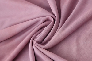 Detailed macro view of soft dark pink mesh fabric with pleated texture for spring dress