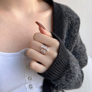 Macro detail of S925 sterling silver leaf ring with marquise zircon on woman finger