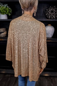 Detailed back view of a loose-fitting gold sequin cardigan with elegant texture