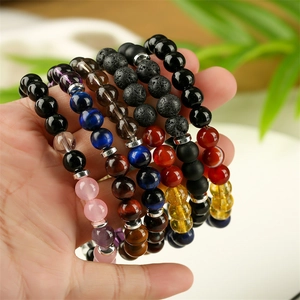 Detailed close-up of colorful tiger eye and lava stone stretch bracelets set for men and women