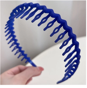 Close-up of deep blue wavy non-slip headband with teeth for secure hair styling