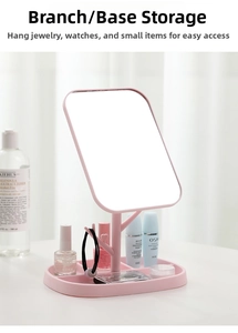 Pink desktop makeup mirror with branch-shaped jewelry hooks and partitioned storage base