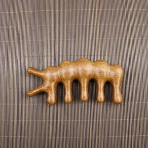 Macro detail of natural sandalwood massage comb with smooth five-tooth meridian design