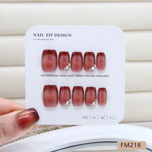 Handmade moonstone cat-eye press-on nails in deep reddish-brown with white rhinestones