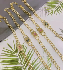 Detailed view of adjustable gold Cuban chain bracelets with star, heart, and cross charms