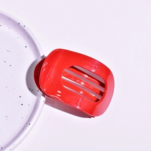 Detailed top-down view of a glossy vibrant red hollow rectangular hair claw clip