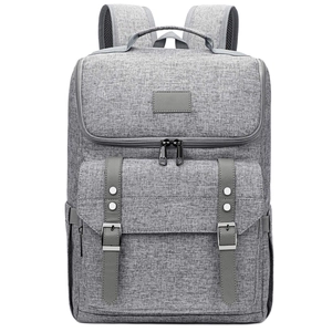 Detailed close-up of grey oxford fabric backpack with dual decorative leather buckle straps