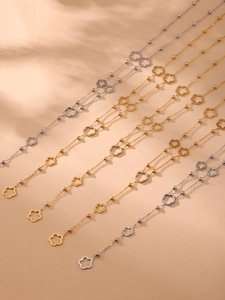 Close-up of gold and silver clover bead necklaces with sparkling pavé zircons