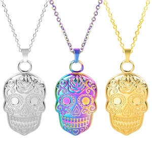 Detailed view of skull pendants in silver, gold, and rainbow finishes with floral carvings