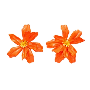 Exaggerated orange acrylic flower earrings with silver needles for a vacation look