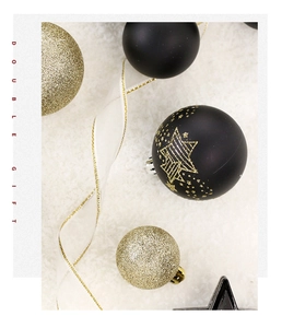 Detailed view of black and gold Christmas ornaments with festive patterns and silk ribbon