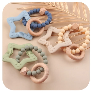 Star-shaped silicone and natural wood baby teether rings in Morandi colors