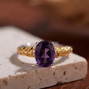 Detailed close-up of S925 silver 18K gold ring with oval amethyst and side diamonds