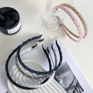 Close-up of thin steel wire headbands with shimmering hand-beaded crystals in multiple colors