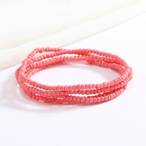 Close-up of pink handmade glass seed bead multi-layer body chain with elastic texture