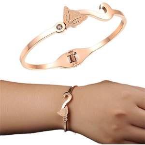 Rose gold fox bangle with sandblasted finish and crystal eye in a two-view composition
