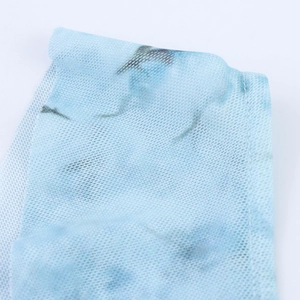 Macro shot of light blue mesh fabric showing intricate net texture and floral print details