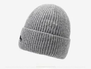 Detail of grey ribbed knit beanie showing the thick wool texture and embroidered logo