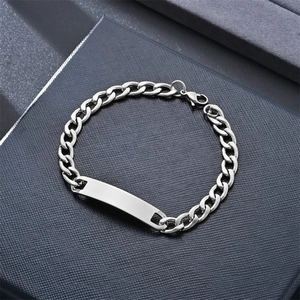 Detail of silver stainless steel Cuban link bracelet with rectangle ID plate on jewelry box