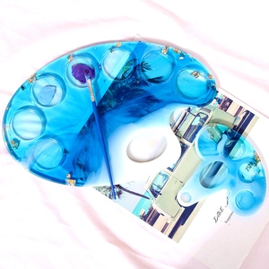 Detailed view of DIY resin ocean palette set with blue swirl texture and gold foil flakes