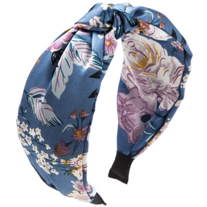 Detail of bohemian knotted headband featuring floral print on light blue fabric