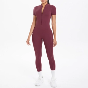 Front view of burgundy one-piece yoga jumpsuit with half-zipper collar and short sleeves