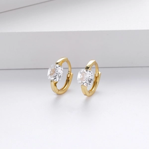 Macro shot of gold S925 sterling silver hoop earrings with square zircon on white stand