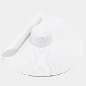 Detailed close-up of wide-brim straw sun hat showing the delicate white woven paper texture