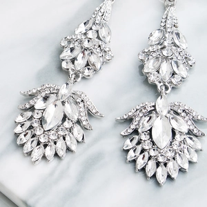 Macro close-up of vintage silver bridal earrings with marquise-cut rhinestones