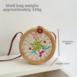 Detail of round rattan bag with seashell mosaic pattern, 20cm diameter and 330g weight
