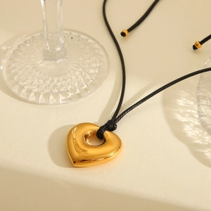 Minimalist gold heart pendant necklace with black wax rope and elegant polished finish