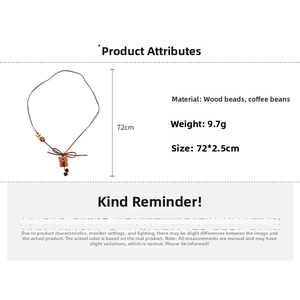 Detail of bear pendant necklace with wooden beads and coffee beans on a long cord