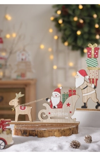 Macro shot of wooden Christmas ornaments featuring Santa Claus on a sleigh and reindeer