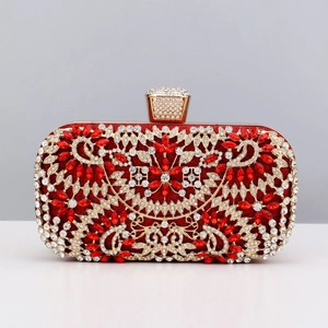 Macro view of luxurious red rhinestones and golden metal frame on bridal clutch