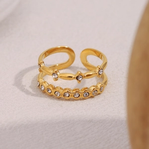 Detail of 18K gold plated double layer ring with star motifs and zircon stones