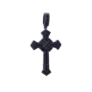 Macro detail of hip hop cross pendant paved with shiny black zircons on white background